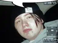 a young man wearing a herschel beanie is taking a picture
