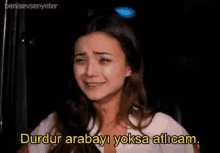 a woman is crying with the words durdur arabayi yoksa atlicam below her