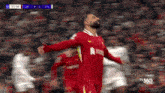 a soccer player with his arms outstretched during a game