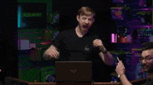 a man in a black shirt with the letters rh on the front