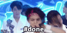 a group of people are standing in front of a sign that says #done on it