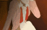 a woman in a pink sweater and red tie is sitting down