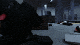 a very dark room with a few boxes on the floor and a speaker that says ' x ' on it