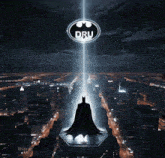 a picture of a batman standing on top of a building with the dru logo above him