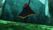 a person with red hair is laying on the ground in front of a rock