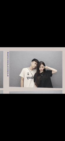 a man and a woman are posing for a picture and the man is wearing a white shirt that says yeaah