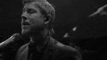 a man in a suit singing into a microphone