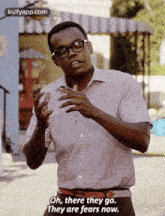 a man wearing glasses and a pink shirt is saying `` oh , there they go they are fears now . ''