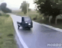 a blurred image of a car driving down a road with the word norbo on the bottom