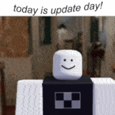 a white cube with a smile on its face and the words today is update day below it