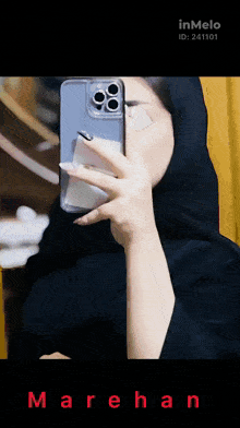 a woman taking a picture of herself in a mirror with the name marehan
