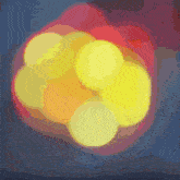 a bunch of yellow circles are surrounded by red circles on a dark background