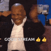 a man in a suit is giving a thumbs up and the words good stream are above him
