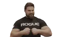 a man flexes his muscles wearing a rogue t-shirt