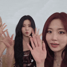 a group of young women are waving at the camera