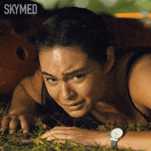 a woman is crawling in the grass with skymed written on the bottom