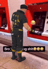 a man in a black uniform with the number 44 on the back is holding a hamburger in his hand
