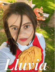 a woman in a red vest is holding a yellow purse and the word luvia is on the bottom