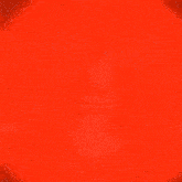 a man is sitting in a chair with his arms outstretched in front of a red background .