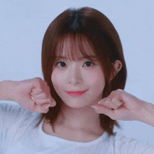 a girl with short hair is making a funny face with her hands