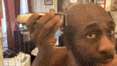 Amin Parker Shaves His Head Completely Bald GIF