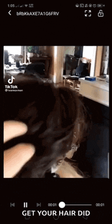 a video of a dog is being played on a cell phone with the words get your hair did at the bottom
