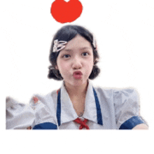 a girl with a red heart on her head making a funny face