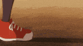 a person wearing a pair of red and white sneakers