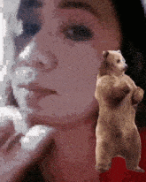 a pixelated image of a woman standing next to a bear