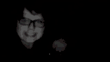 a black and white photo of a person 's face in a dark room .