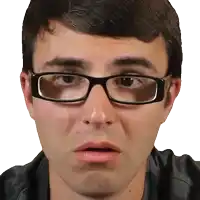a close up of a man wearing glasses and making a funny face