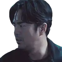 a close up of a man 's face with a black shirt on