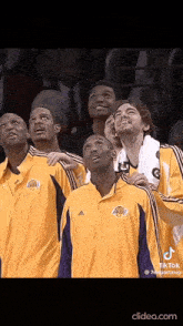 a group of basketball players wearing lakers jerseys