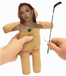 a person is holding a reebok hockey stick and a stuffed doll with a picture of a woman on it