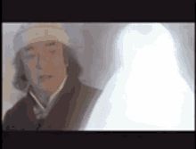 a man and a ghost are standing next to each other on a screen .