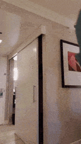 a woman is jumping in the air in front of a white door