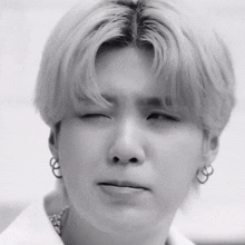 a close up of a person making a funny face with their eyes closed .