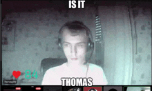 a man wearing headphones with the caption " is it thomas " behind him