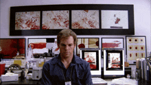 a man with a name tag that says ' dexter ' on it sits at a desk