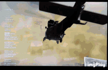 a computer screen shows a helicopter flying over a desert and the words " imgplay " at the bottom