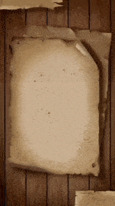 an old piece of paper is hanging on a wooden wall .