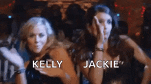 two women are standing next to each other in a club and dancing .