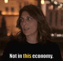a woman says " not in this economy " in yellow