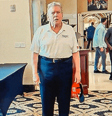 a man wearing a white shirt with the word lodge on the front