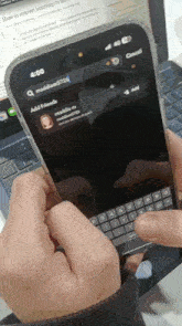 a person is holding a cell phone in front of a laptop that says how to convert headdump to text on the screen
