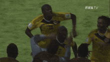 a group of soccer players on a field with fifa tv in the corner