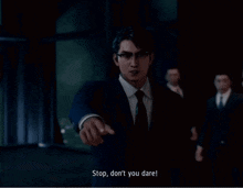 a man in a suit and tie points at the camera with the words stop don 't you dare below him