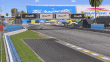 a race track with a large techsports sign in the background