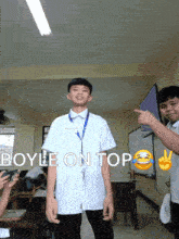 a boy in a white shirt is standing in a classroom with the words boyle on top written above him