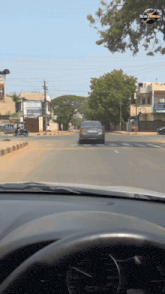 a car is driving down a street with a speedometer that goes up to 400